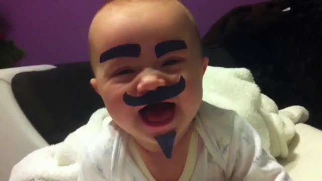 Un bébé avec une fausse moustache