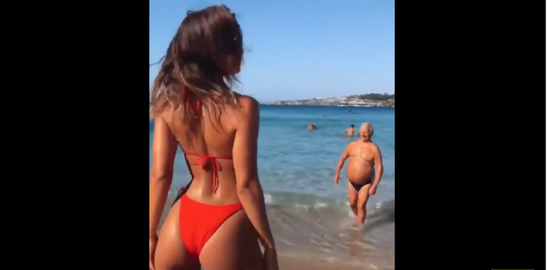 Un papy vole la vedette à une top modèle qui fait la belle sur la plage