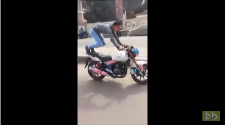 Un abruti fait des pompes sur sa moto